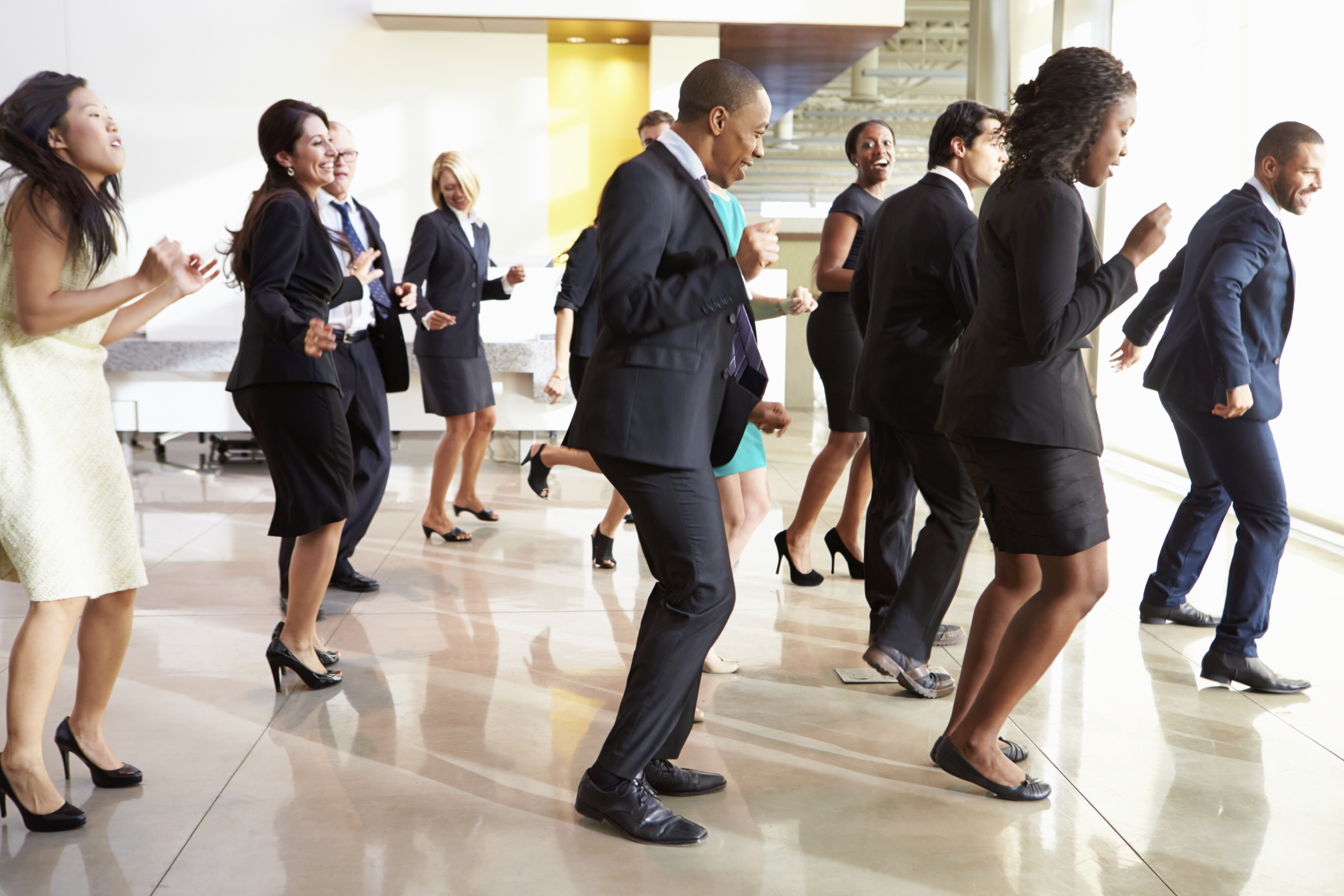Businesspeople dancing in lobby